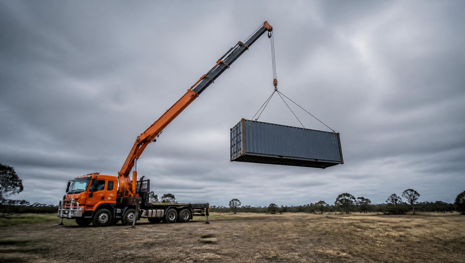 Crane truck set up with outriggers ready to lift on site